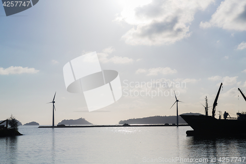 Image of turbines at wind farm on sea shore