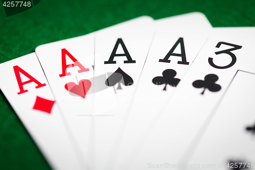 Image of poker hand of playing cards on green casino cloth