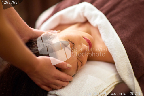 Image of woman having head massage at spa