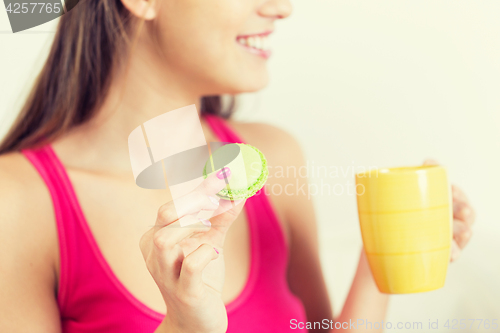 Image of close up of happy woman or teen girl with cookie 