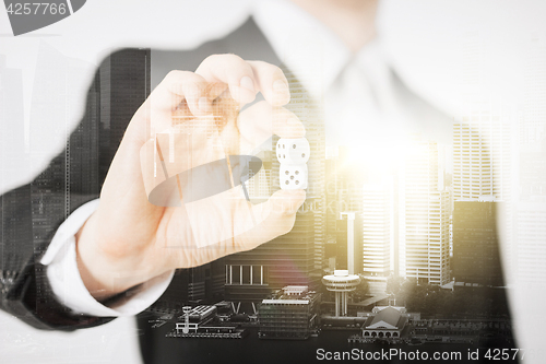 Image of close up of businessman hand holding casino dice