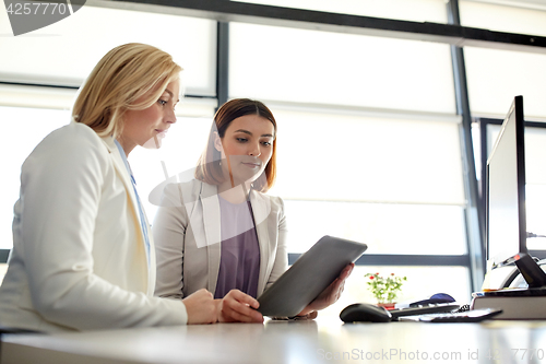 Image of businesswomen with tablet pc computer at office