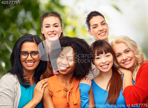 Image of international group of happy women hugging