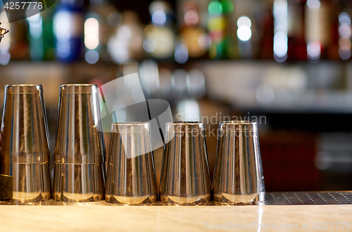Image of stainless steel shakers on bar counter