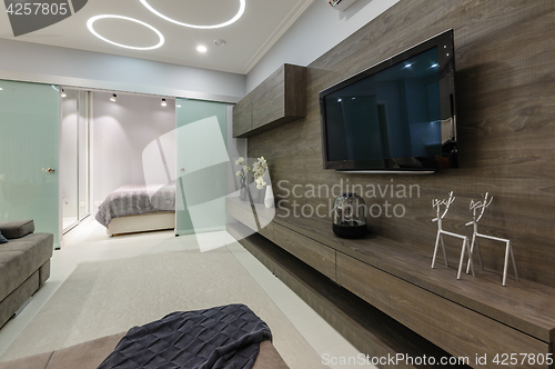 Image of Modern white living studio with bedroom doors open
