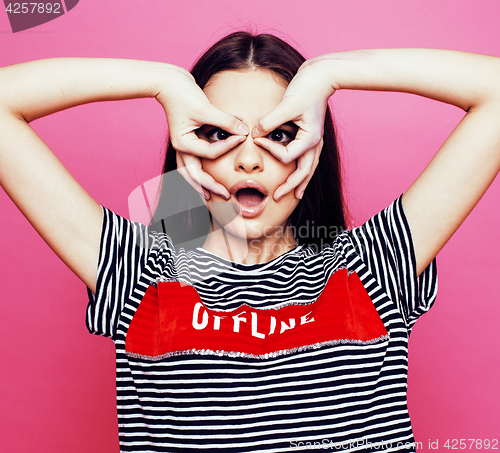 Image of young pretty teenage woman emotional posing on pink background, fashion lifestyle people concept