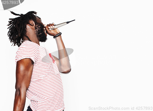 Image of young handsome african american boy singing emotional with microphone isolated on white background, in motion gesturing smiling, lifestyle people concept 