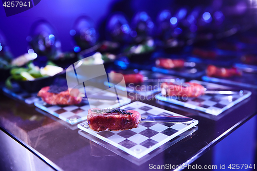 Image of Beautifully decorated catering banquet table with different food snacks.