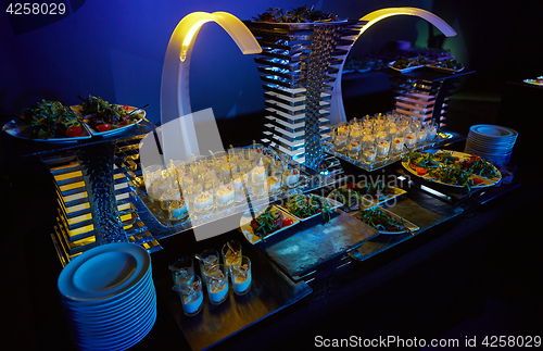 Image of Beautifully decorated catering banquet table with different food snacks.