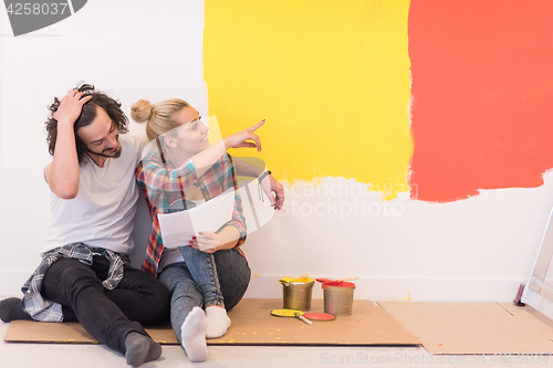 Image of Happy young couple relaxing after painting