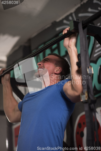 Image of man doing pull ups