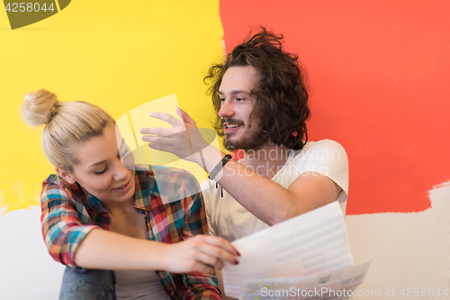 Image of Happy young couple relaxing after painting