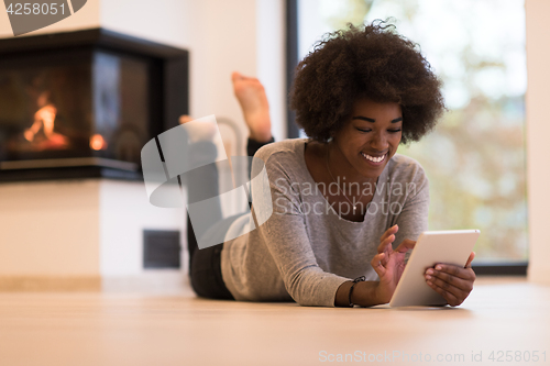 Image of black women using tablet computer on the floor