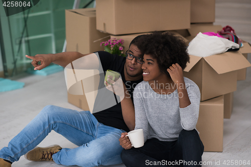 Image of African American couple relaxing in new house