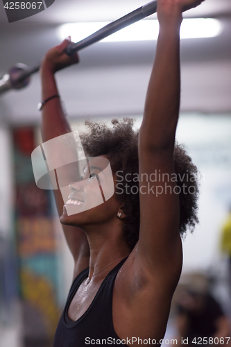 Image of black woman lifting empty bar