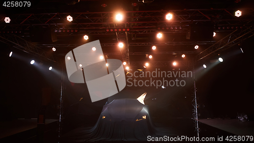 Image of Close up of a new car hidden under cover.