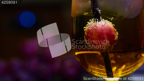 Image of Grapes floating in champagne creating lots of bubbles