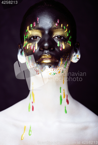 Image of woman with creative makeup closeup like drops of colors, facepai