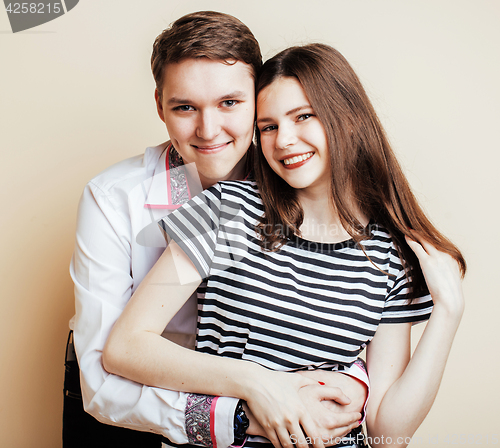 Image of couple of happy smiling teenagers students, warm colors having a