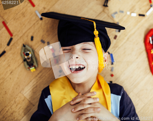 Image of little cute preschooler boy among toys lego at home in graduate 