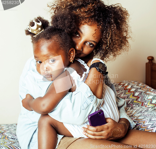 Image of adorable sweet young afro-american mother with cute little daugh