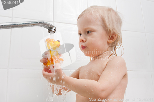 Image of girl playing with water in the bath