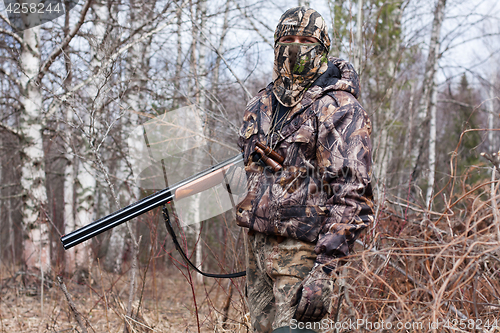 Image of hunter in the camouflage with gun