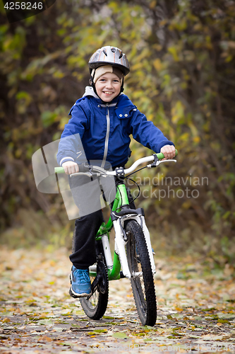 Image of boy rides a bike