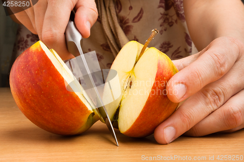 Image of hands cutting an apple