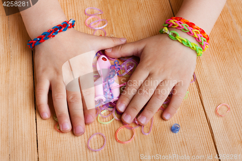 Image of child hands with rubber bands