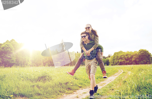 Image of happy couple with backpacks having fun outdoors