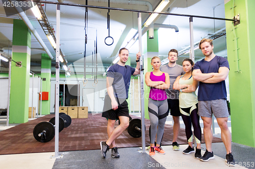 Image of group of happy friends in gym