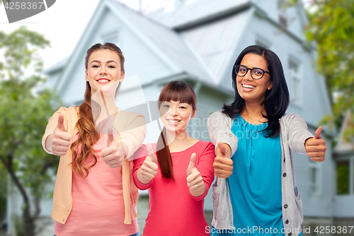 Image of international happy women showing thumbs up