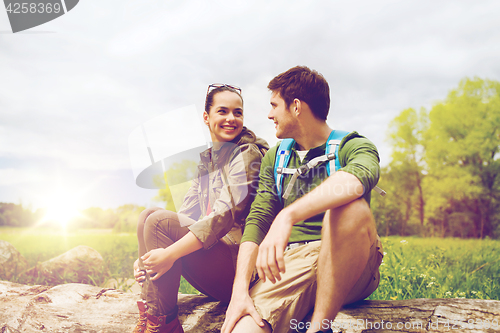 Image of smiling couple with backpacks in nature