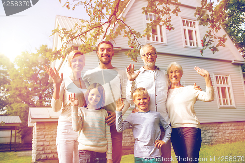 Image of happy family in front of house outdoors