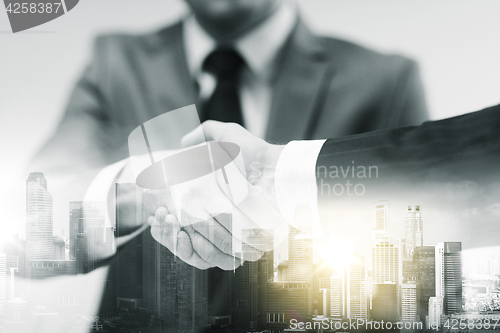 Image of two businessmen shaking hands at office