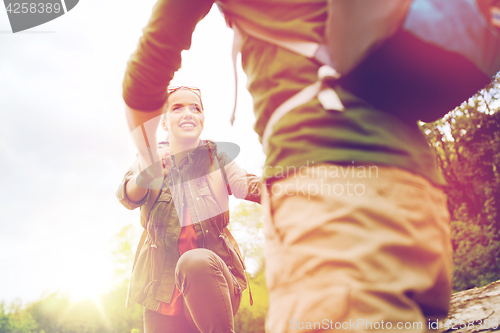 Image of smiling couple with backpacks hiking