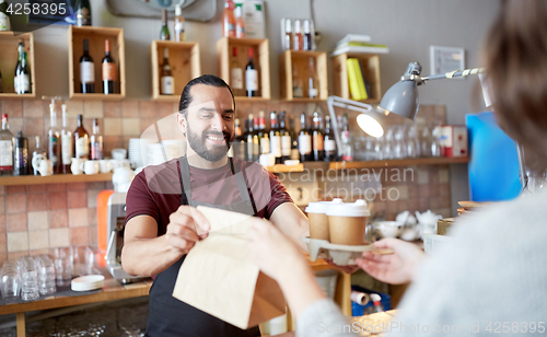 Image of man or waiter serving customer at coffee shop