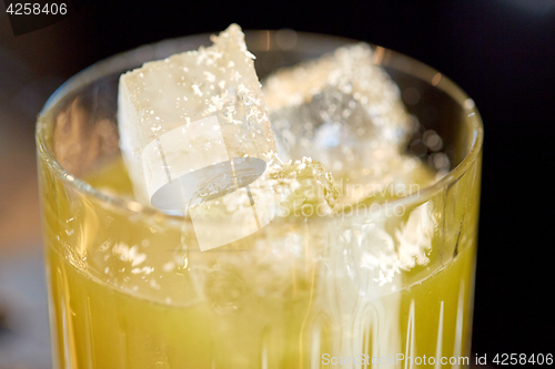 Image of close up of glass with cocktail at bar