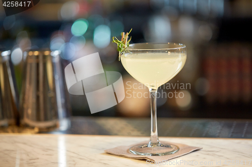 Image of glass of cocktail at bar