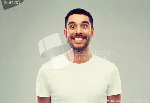 Image of man with funny face over gray background
