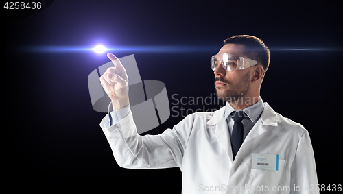 Image of doctor or scientist in goggles with laser ray