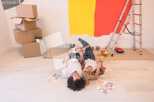 Image of Happy young couple relaxing after painting