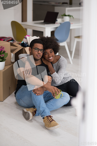 Image of African American couple relaxing in new house