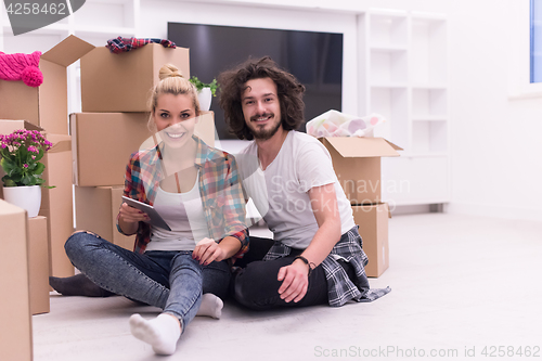 Image of young couple moving  in new house