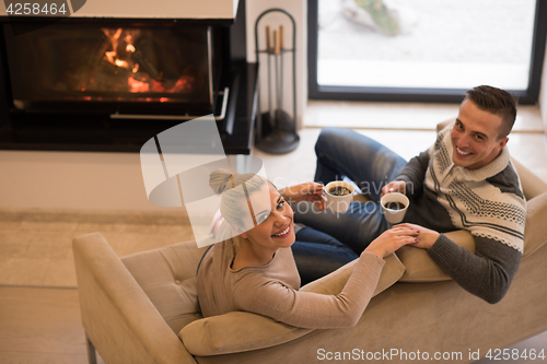 Image of Young couple  in front of fireplace