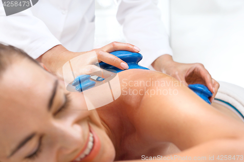 Image of Masseur massaging her back rubber Chinese bubble.