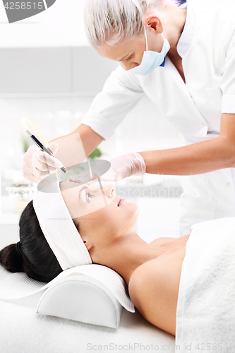 Image of Relaxed woman during a microdermabrasion treatment in beauty salon