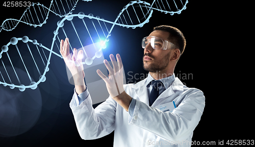 Image of scientist in lab coat and safety glasses with dna