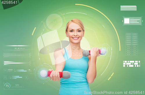 Image of happy sporty woman with dumbbells flexing biceps